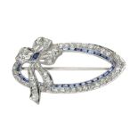 A DIAMOND AND SAPPHIRE BROOCH in white gold or platinum, designed as an oval ribbon motif jewelled