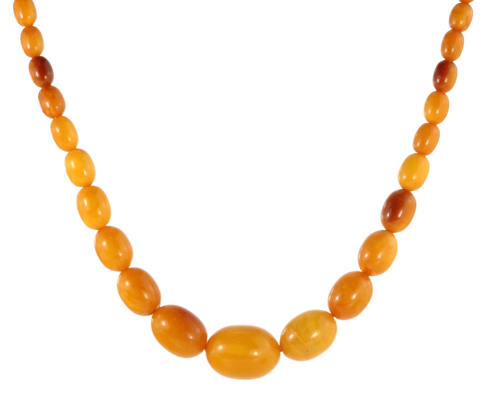 A NATURAL AMBER BEAD NECKLACE comprising a single row of forty graduated polished oval beads up to