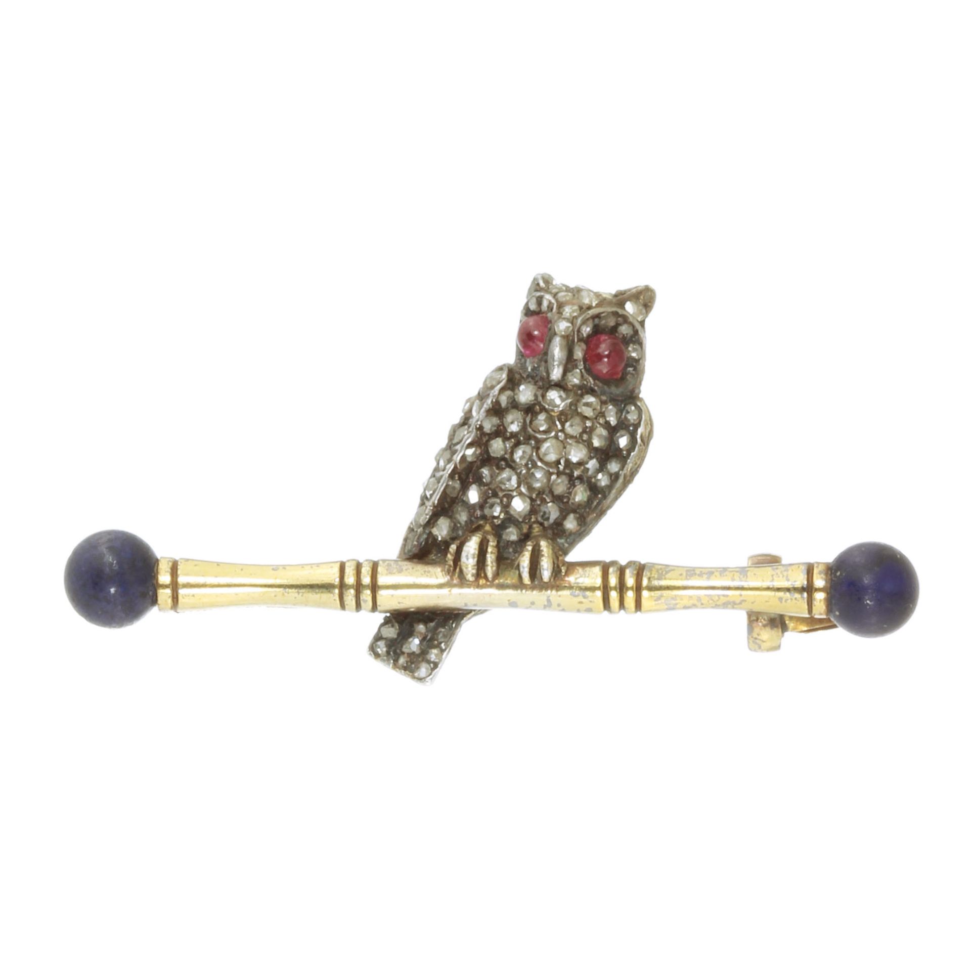 A DIAMOND, RUBY AND LAPIS LAZULI OWL BROOCH in yellow gold and silver, designed as an owl, its