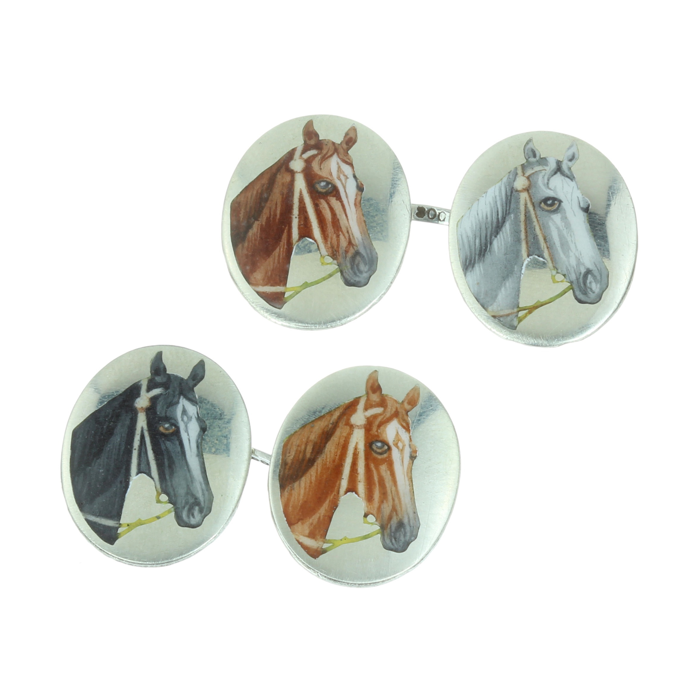 A PAIR OF ANTIQUE ENAMEL HORSE CUFFLINKS in silver, each formed of two oval faces decorated in