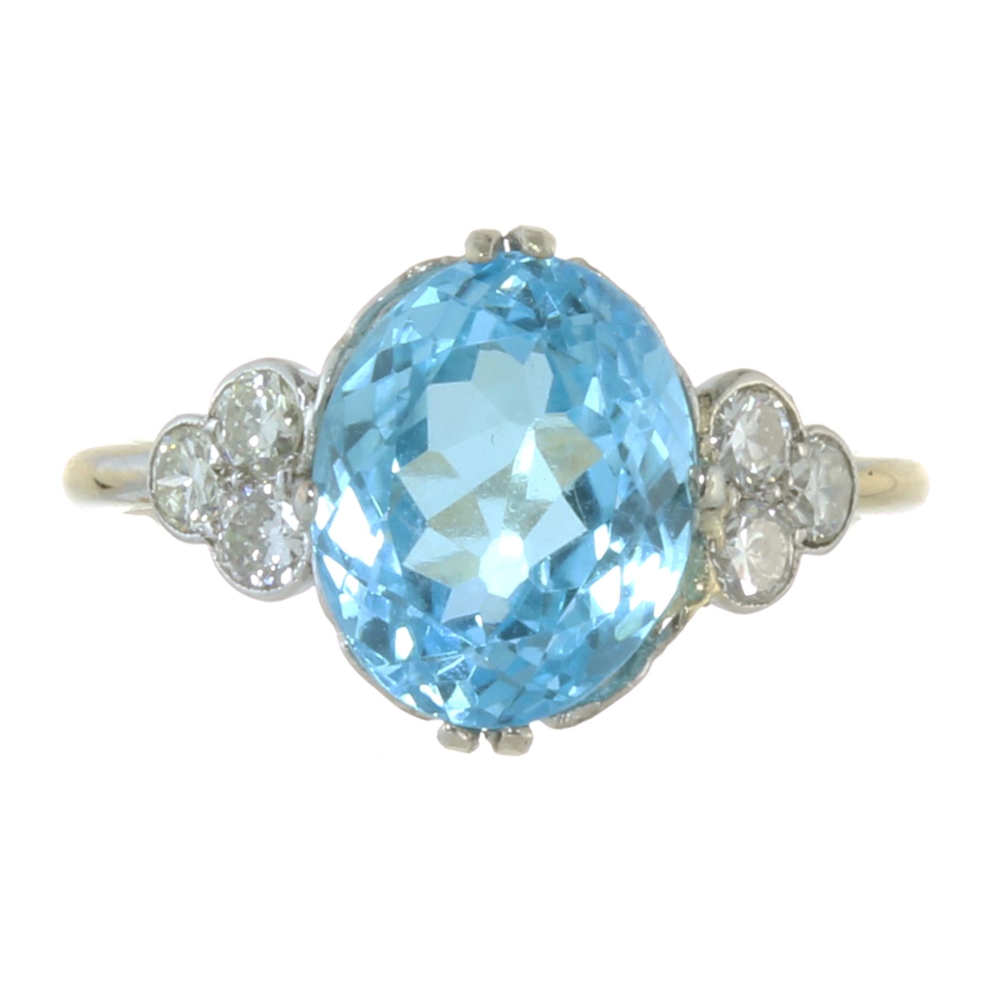 A BLUE TOPAZ AND DIAMOND DRESS RING in 18ct yellow gold and platinum, set with a central oval cut
