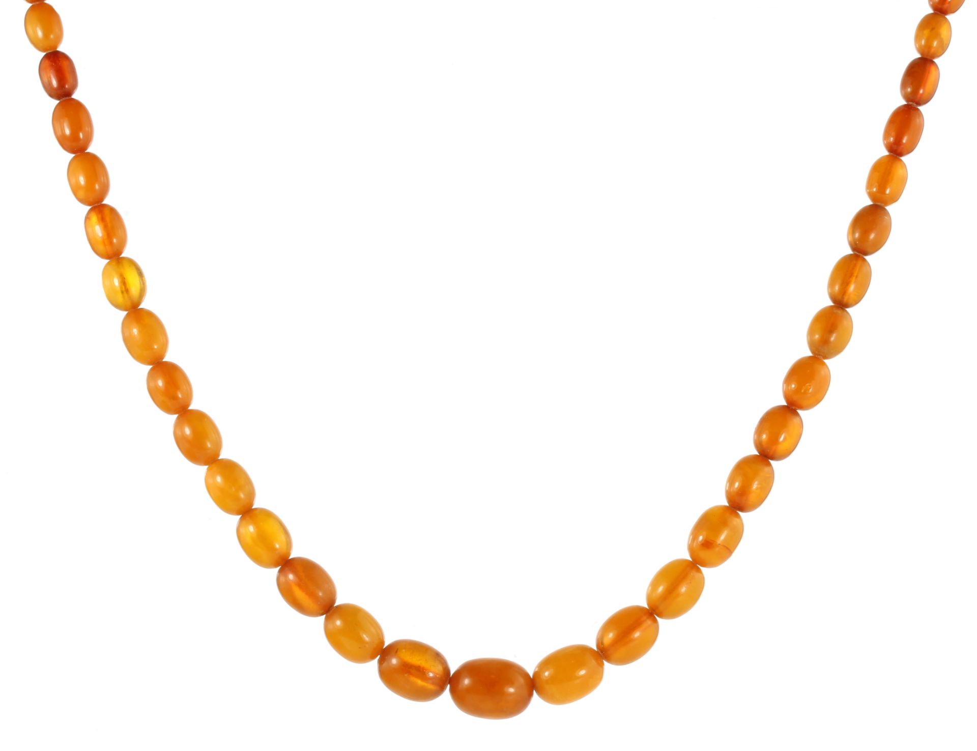 A NATURAL AMBER BEAD NECKLACE comprising a single row of fifty-five graduated polished oval beads up