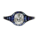 A DIAMOND AND SAPPHIRE DRESS RING in white gold or platinum, set with a central old mine cut diamond