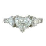 A HEART SHAPED DIAMOND DRESS RING in white gold or platinum, set with a central heart shaped