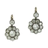 A PAIR OF DIAMOND CLUSTER EARRINGS in platinum, each set with a central old mine cut diamond