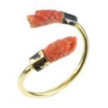 AN ANTIQUE ART DECO CARVED CORAL AND BLACK ENAMEL BANGLE in high carat yellow gold, the incomplete