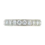 A DIAMOND ETERNITY RING in white gold or platinum, the band set completely around with round cut
