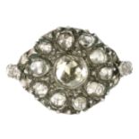 AN ANTIQUE DIAMOND CLUSTER RING in high carat yellow gold and silver set with a central rose cut