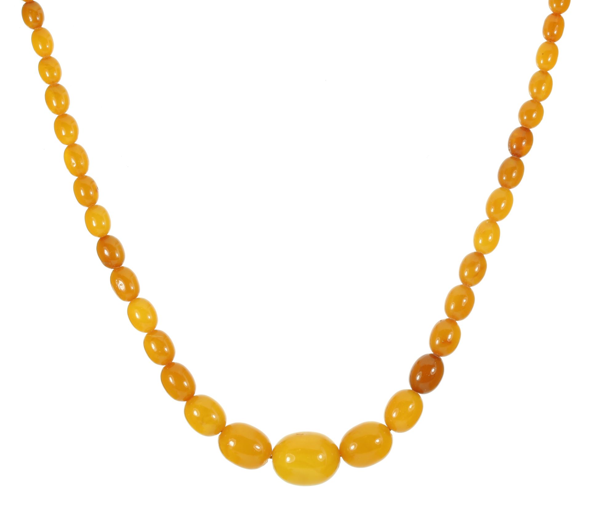 A NATURAL AMBER BEAD NECKLACE comprising a single row of fifty-seven graduated polished oval beads