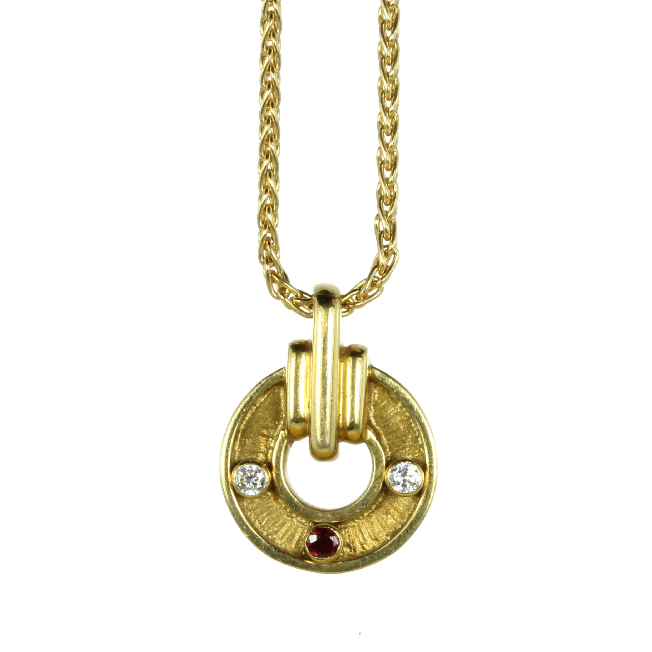 A VINTAGE RUBY AND DIAMOND PENDANT, KUTCHINSKY in 18ct yellow gold, the circular motif with textured