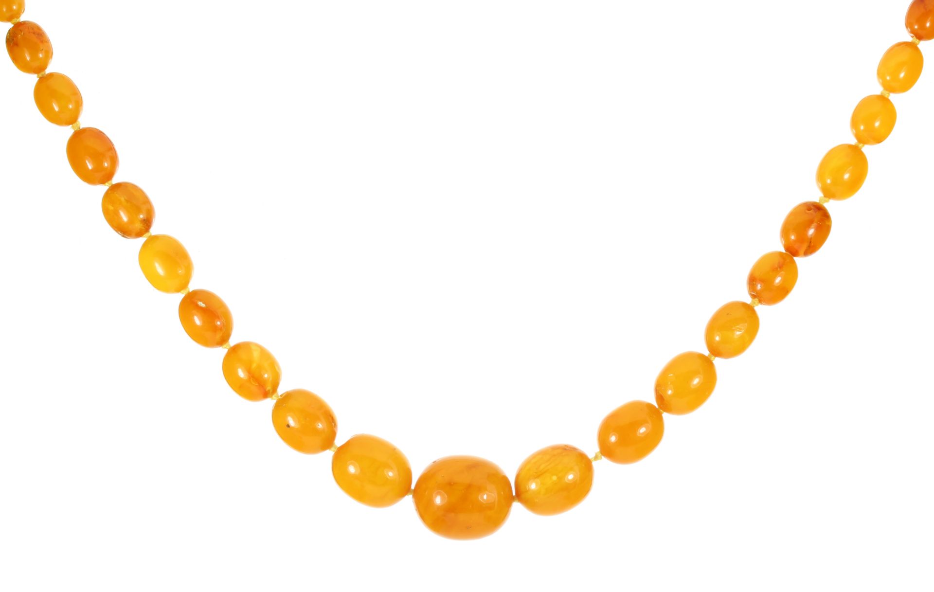 A NATURAL AMBER BEAD NECKLACE comprising a single row of forty-nine graduated polished oval beads up