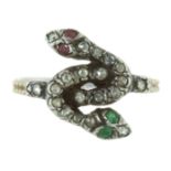 A RUBY, EMERALD AND DIAMOND DOUBLE SNAKE RING in yellow gold and silver, designed as two