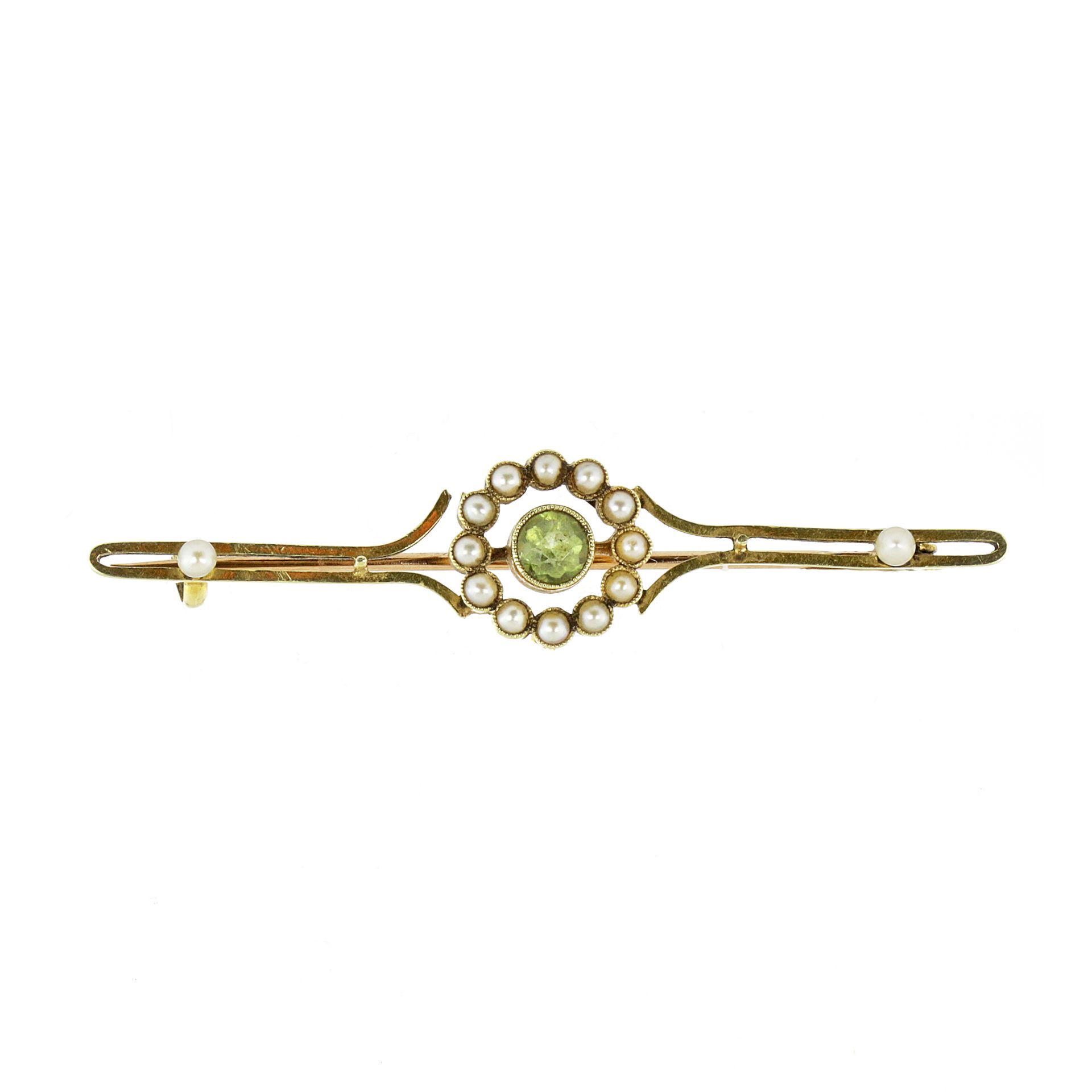 AN ANTIQUE PERIDOT AND SEED PEARL BROOCH in high carat yellow gold set with a central round cut