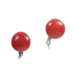 A PAIR OF CORAL STUD EARRINGS in high carat yellow gold, each set with a single coral bead of 8.7mm,