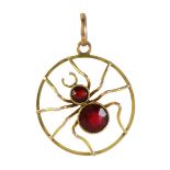 A GARNET SPIDER PENDANT in yellow gold, designed as a spider, its body set with two graduated