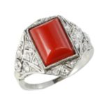 AN ART DECO CORAL AND DIAMOND DRESS RING in white gold or platinum, set with a rectangular coral