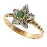 AN ANTIQUE EMERALD AND DIAMOND RING in yellow gold set with a central round cut emerald and five