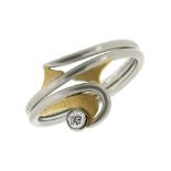 A DIAMOND DRESS RING in 18ct gold and platinum, the scrolling body is set with a round cut