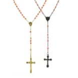 TWO CORAL ROSARY BEAD NECKLACES one in silver, the other in yellow metal, each set with polished