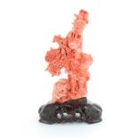 A CHINESE CARVED CORAL STATUE carved in detail to depict an elderly gentleman in traditional garb,