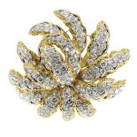 A 14.0 CARAT DIAMOND PENDANT / BROOCH in high carat yellow and white gold, modeled as a foliate