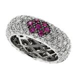 A DIAMOND AND RUBY ETERNITY RING in 18ct white gold comprising five rows of round cut diamonds