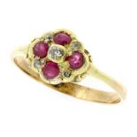 AN ANTIQUE RUBY AND DIAMOND RING in yellow gold, set with four round cut rubies totalling