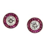 A PAIR OF DIAMOND AND RUBY STUD EARRINGS in white gold or platinum, each set with a round cut