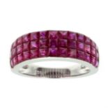 A RUBY HALF ETERNITY RING in 18ct white gold, comprising three rows of graduated step cut rubies,