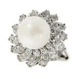 A PEARL AND DIAMOND CLUSTER DRESS RING in white gold or platinum, set with a central pearl of 11.8mm