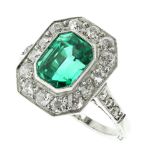 A COLOMBIAN EMERALD AND DIAMOND DRESS RING in white gold or platinum, set with an emerald cut