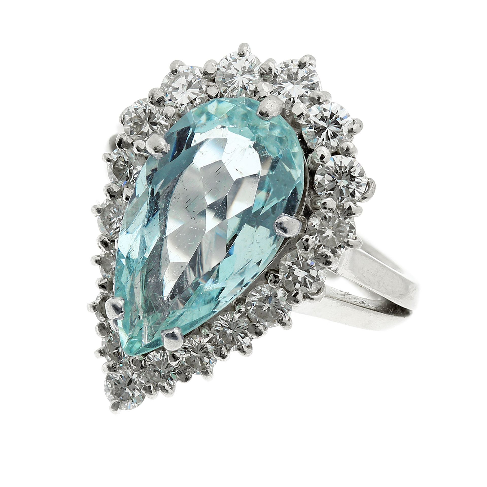 AN AQUAMARINE AND DIAMOND CLUSTER RING in platinum, set with a central pear cut aquamarine of 3.35