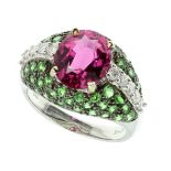 A PINK AND GREEN GARNET AND DIAMOND DRESS RING in 18ct white gold, set with a central oval cut