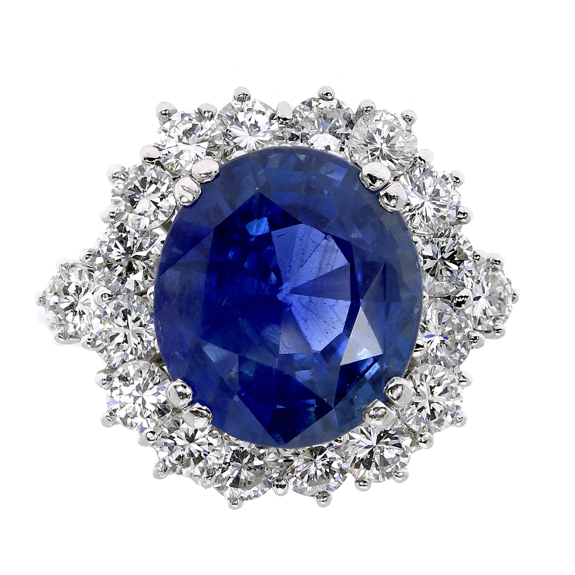 A 9.71 CARAT BURMA NO HEAT SAPPHIRE AND DIAMOND RING in 18 carat white gold, the central oval cut