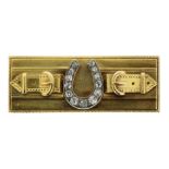 AN ANTIQUE DIAMOND HORSESHOE AND BUCKLE BROOCH in yellow gold, the gold bar set at the centre with a