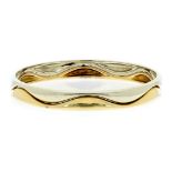 A CARTIER BANGLE, in 18ct white and yellow gold, designed as two undulating elements joined to