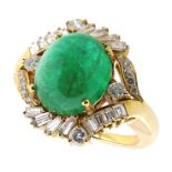 AN EMERALD AND DIAMOND DRESS RING in 18ct yellow and white gold, set with a central cabochon emerald