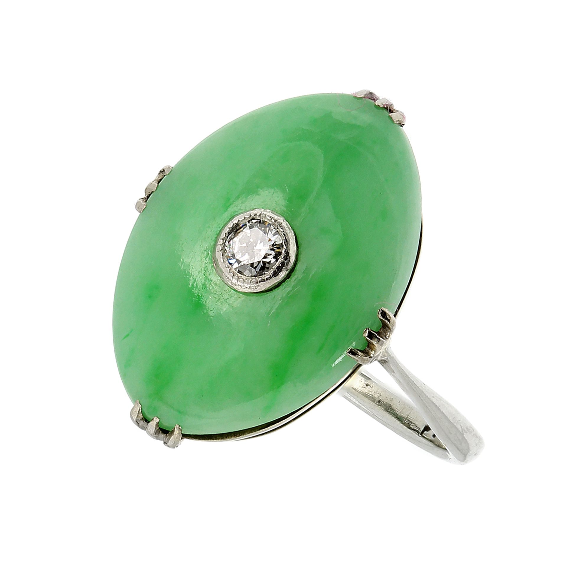 AN ART DECO JADEITE JADE AND DIAMOND DRESS RING CIRCA 1930 in 18ct white gold, the face formed of an