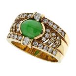 A JADEITE JADE AND DIAMOND DRESS RING in 18ct yellow gold set with a central oval jade cabochon