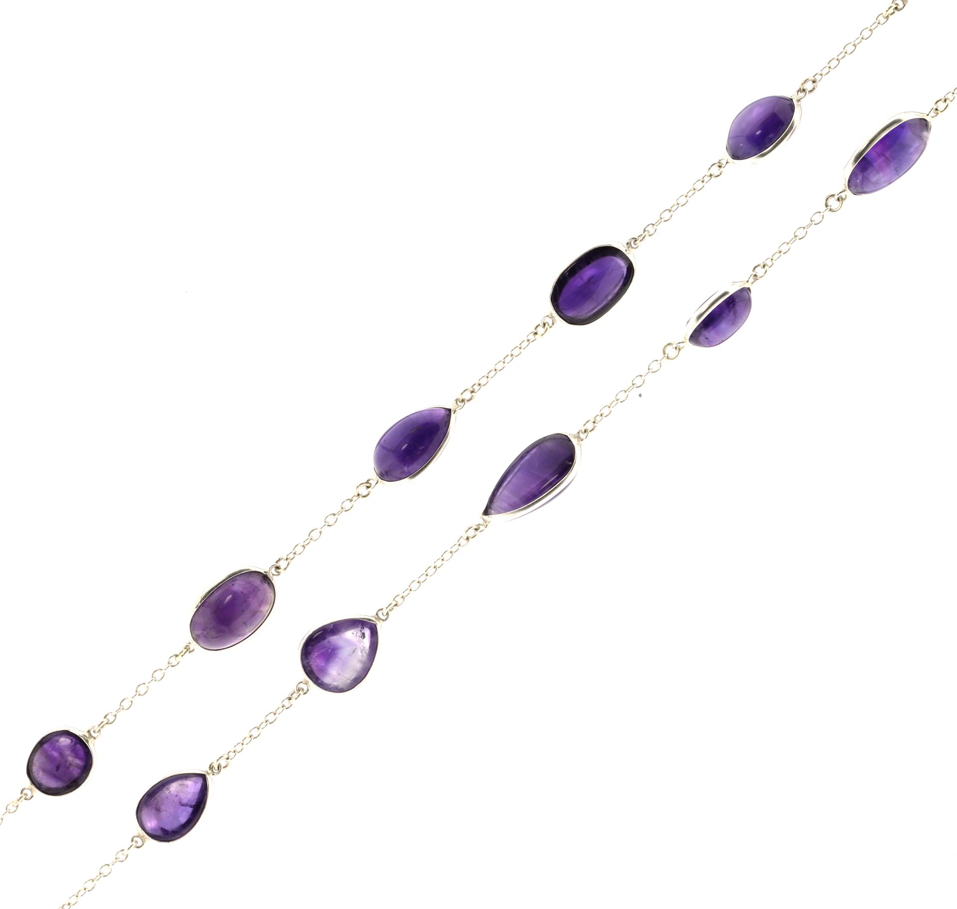 AN AMETHYST SAUTOIR NECKLACE in sterling silver, comprising a long chain jewelled with variously