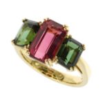 A PINK AND GREEN TOURMALINE DRESS RING in 18ct yellow gold, set with a central emerald cut pink