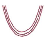 A FACETED GARNET BEAD NECKLACE comprising three rows of graduated faceted garnet beads.