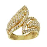 A DIAMOND DRESS RING in high carat yellow gold, in the manner of Boucheron, designed as a twisted