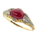 A RUBY AND DIAMOND DRESS RING in 18ct yellow gold, set with a cabochon ruby flanked by diamond set