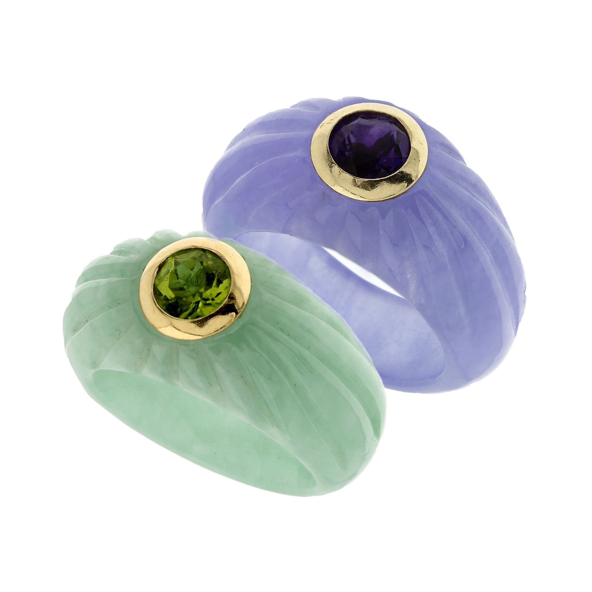 A PAIR OF JADE, PERIDOT AND AMETHYST DRESS RINGS in 14ct yellow gold, each ring carved in jade,