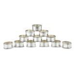 A SET OF TWELVE STERLING SILVER NAPKIN RINGS BY REID & SONS LTD, SHEFFIELD 1994 each of oval form