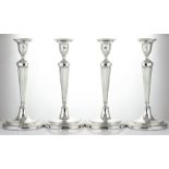 A SET OF FOUR ANTIQUE GEORGE III STERLING SILVER CANDLESTICKS BY JOHN PARSONS & CO, SHEFFIELD 1787