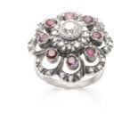 AN ANTIQUE DIAMOND AND RUBY CLUSTER RING in gold and silver, set with a central round cut diamond of