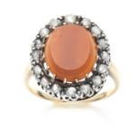 AN ANTIQUE CARNELIAN AND DIAMOND CLUSTER RING in yellow gold and silver, set with a central oval