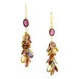 A PAIR OF TOURMALINE AND GARNET CLUSTER EARRINGS in yellow gold, each formed of a cluster of oval